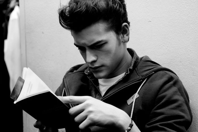 The-Miseducation-of-the-Poet--High-School-and-the-Fear-of-Poetry, black and white photo of man reading book