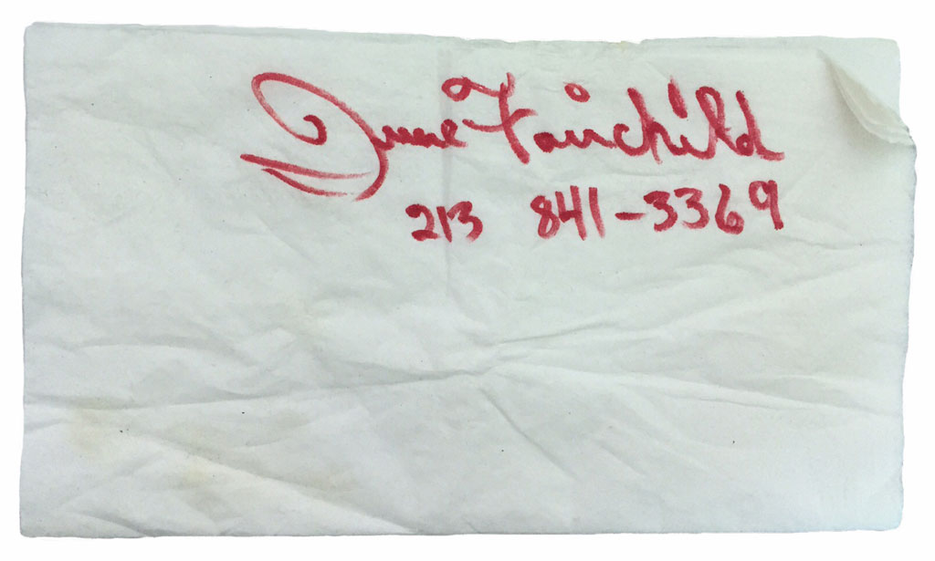 Name and phone number scrawled on a white napkin (June Fairchild, 213 841-3369)