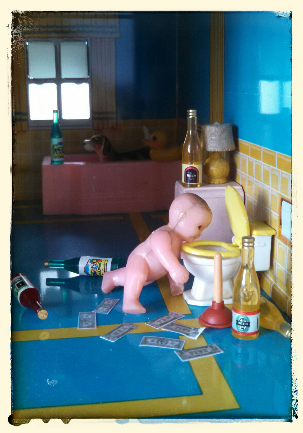 plastic toy baby in dollhouse bathroom