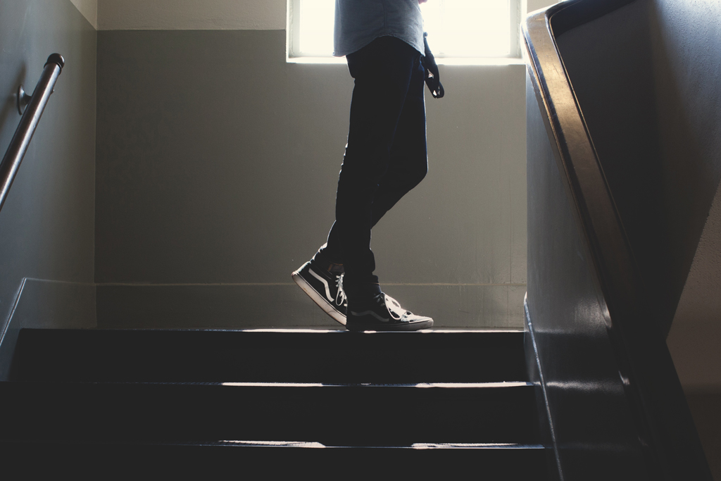Man in vans walking up steps