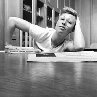 Claire Rudy Foster sitting at a wooden table