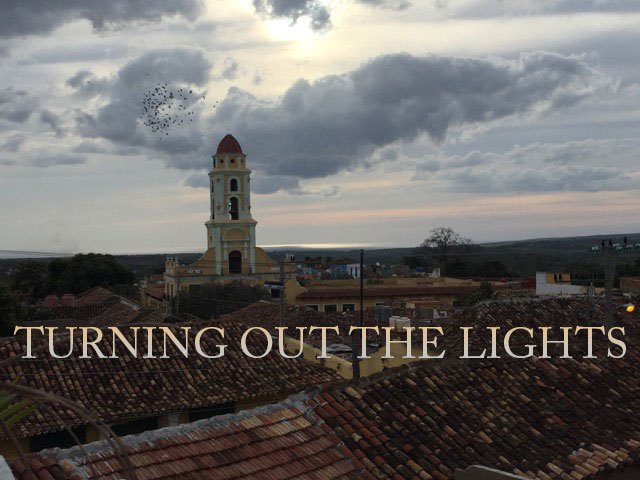 spire against clouded sky with text saying 'turning out the lights'