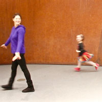 Lucy Anderson walking across a room with her daughter