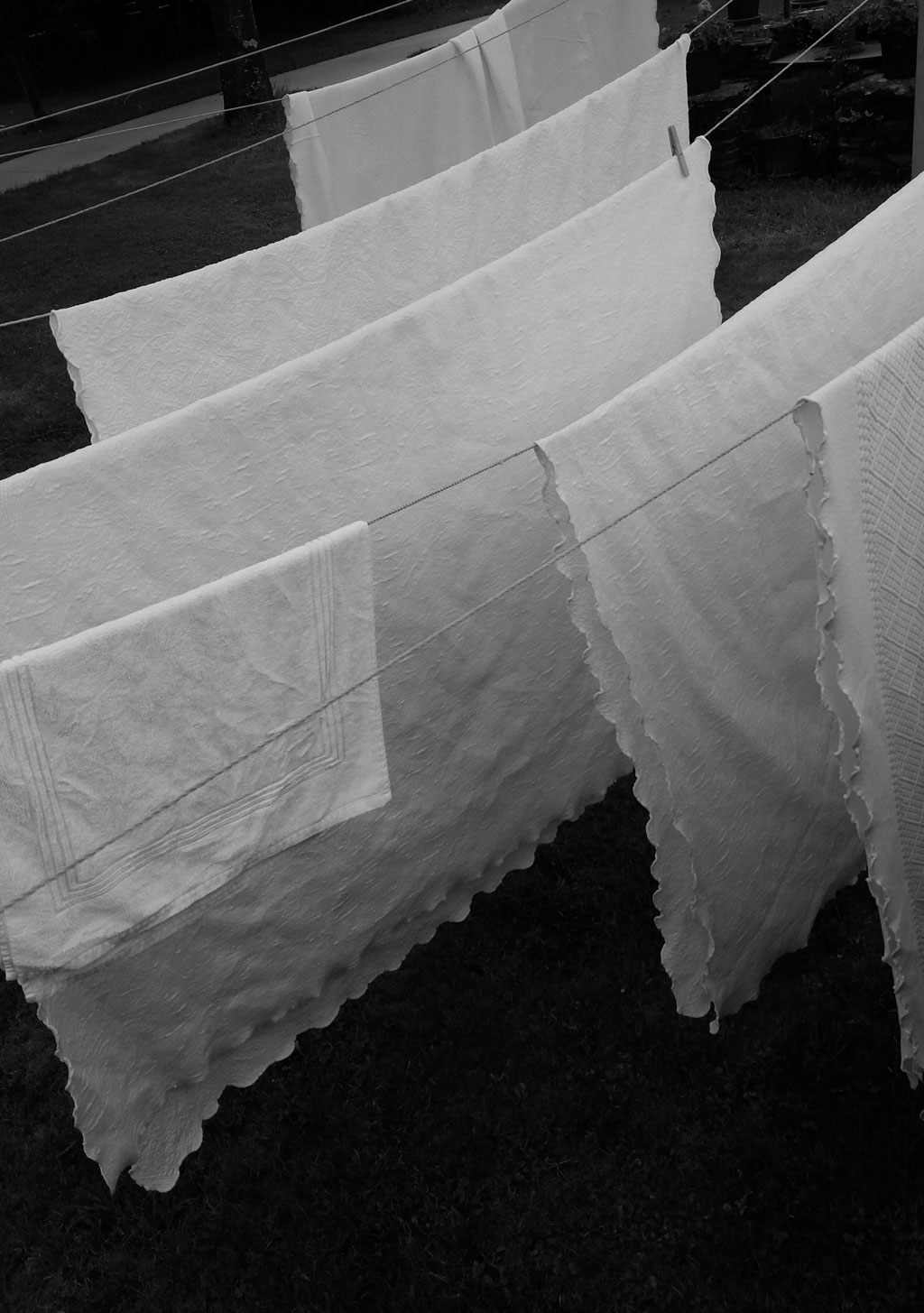 White linens hanging on clothes lines