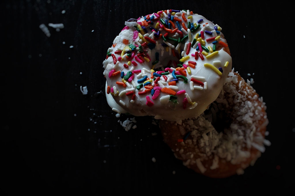 White glazed donut with rainbow sprinkles