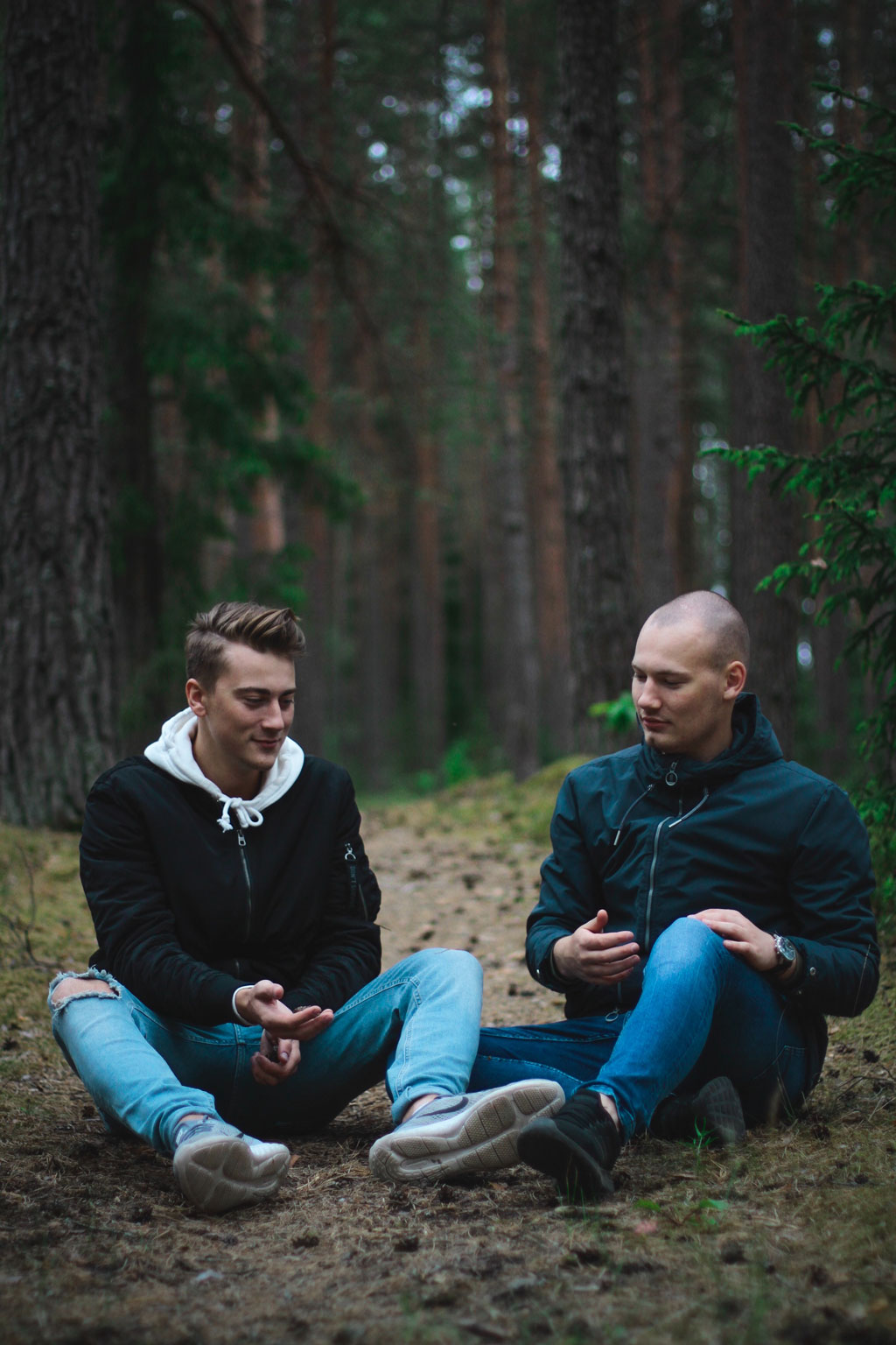 Two men sitting in the woods