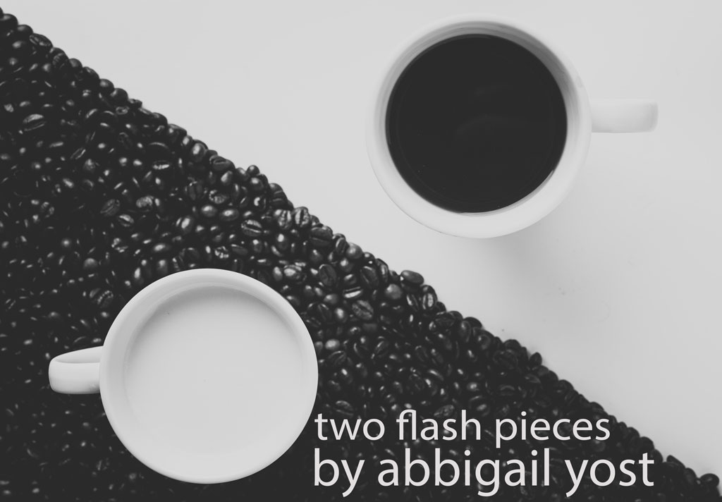 Two mugs on a table, one filled with milk and one filled with coffee, with coffee beans underneath the mug of milk to resemble a yin-yang symbol, with the title of the piece in the foreground