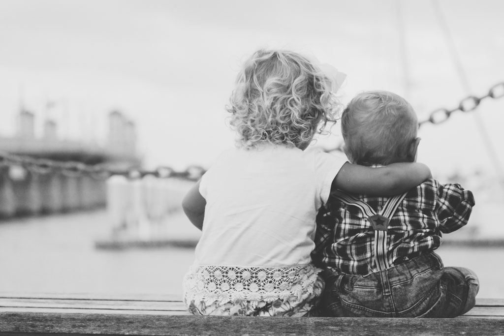 BW photo of two toddler-age children at water's edge