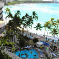 View of ocean, beach, palm trees in Waikiki from a high balcony