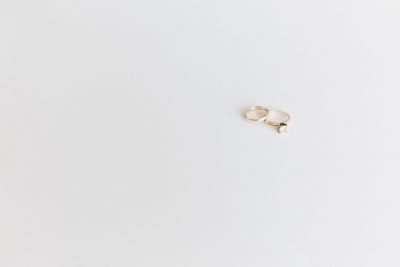 Two gold wedding rings on white background