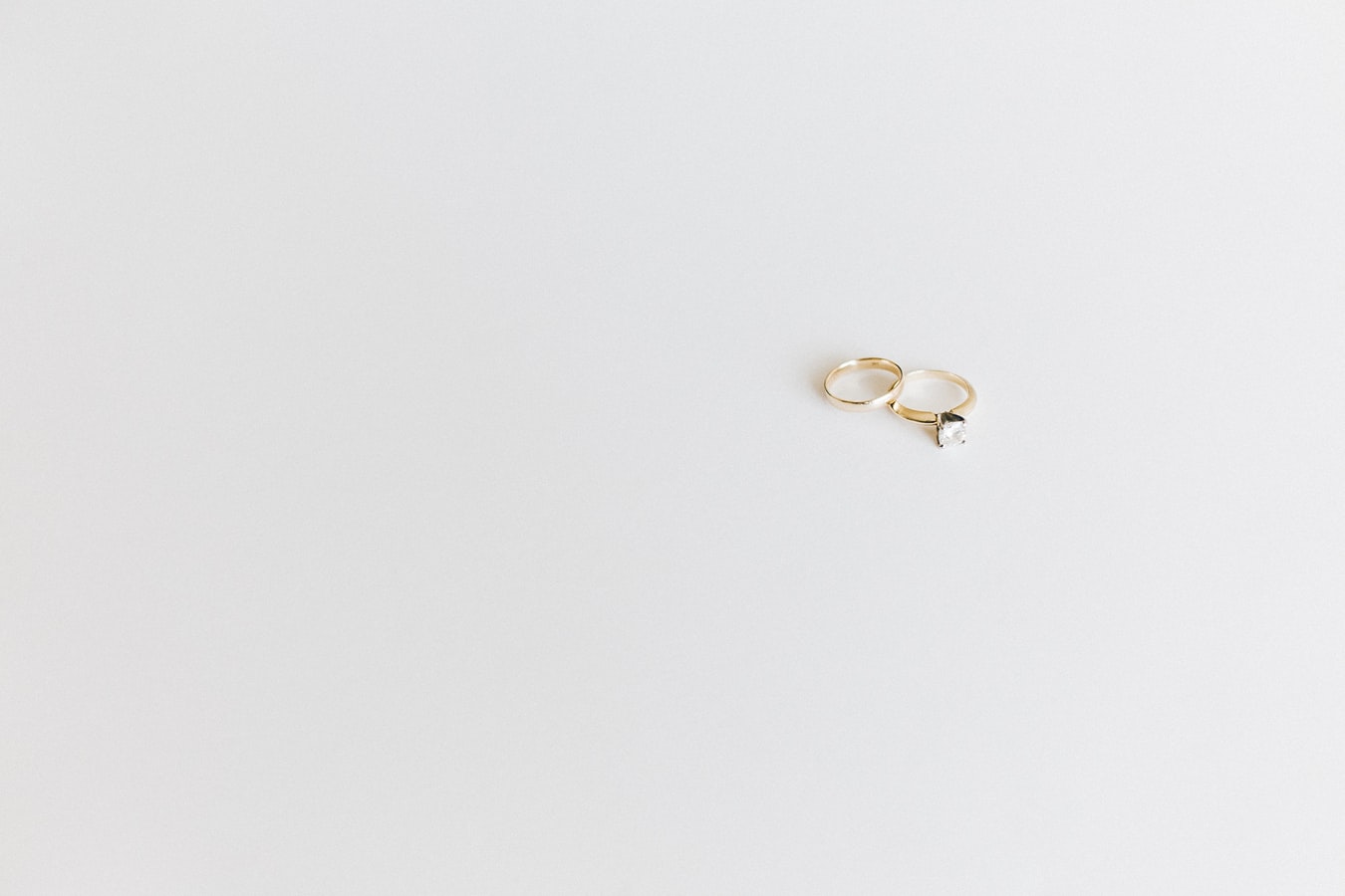 Two gold wedding rings on white background