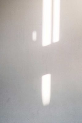 a white wall with shadows and sunlight