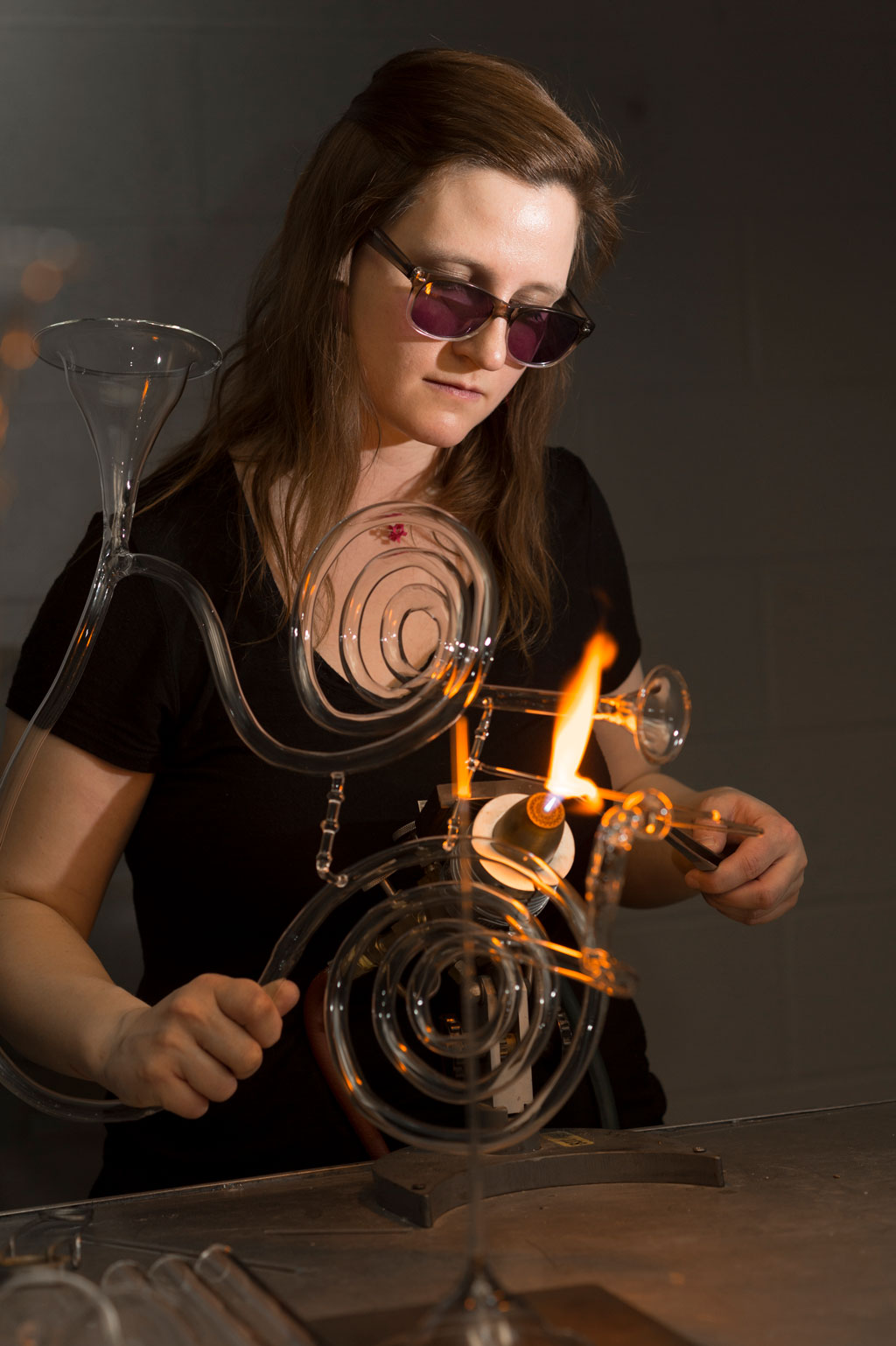 Madeline Rile Smith flameworking a glass instrument