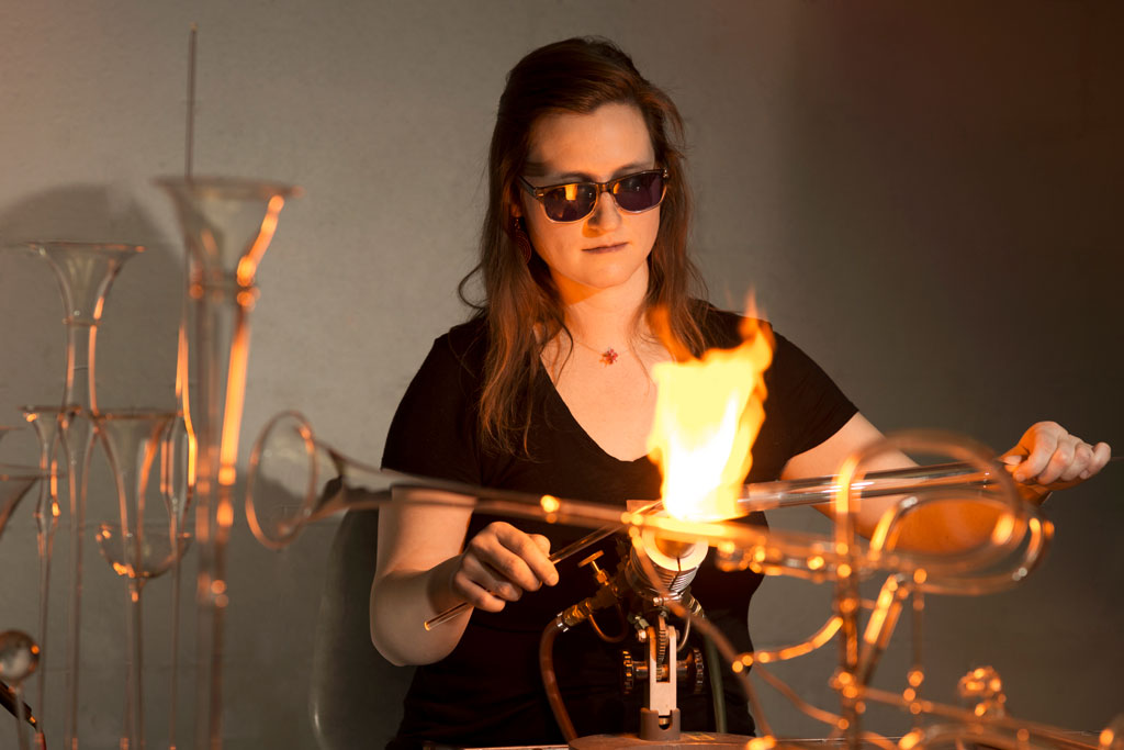 Madeline Rile Smith making a glass trumpet on the torch.