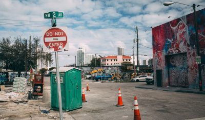 A street scene from Miami-Dade Florida. traffic cones, graffiti