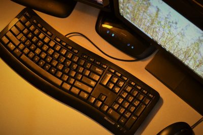 Image of a computer keyboard in an office at night
