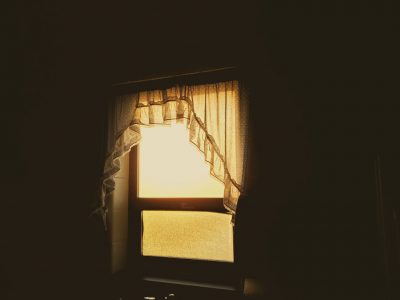 A dark room with a bright window