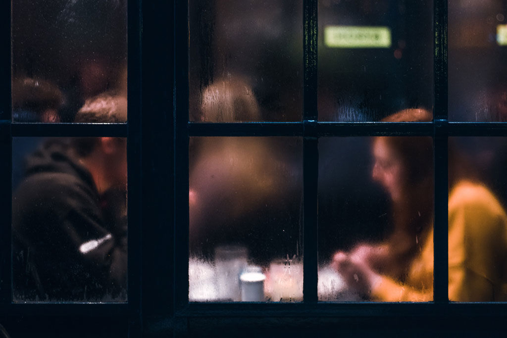 A Man and a Woman behind a fogged class window
